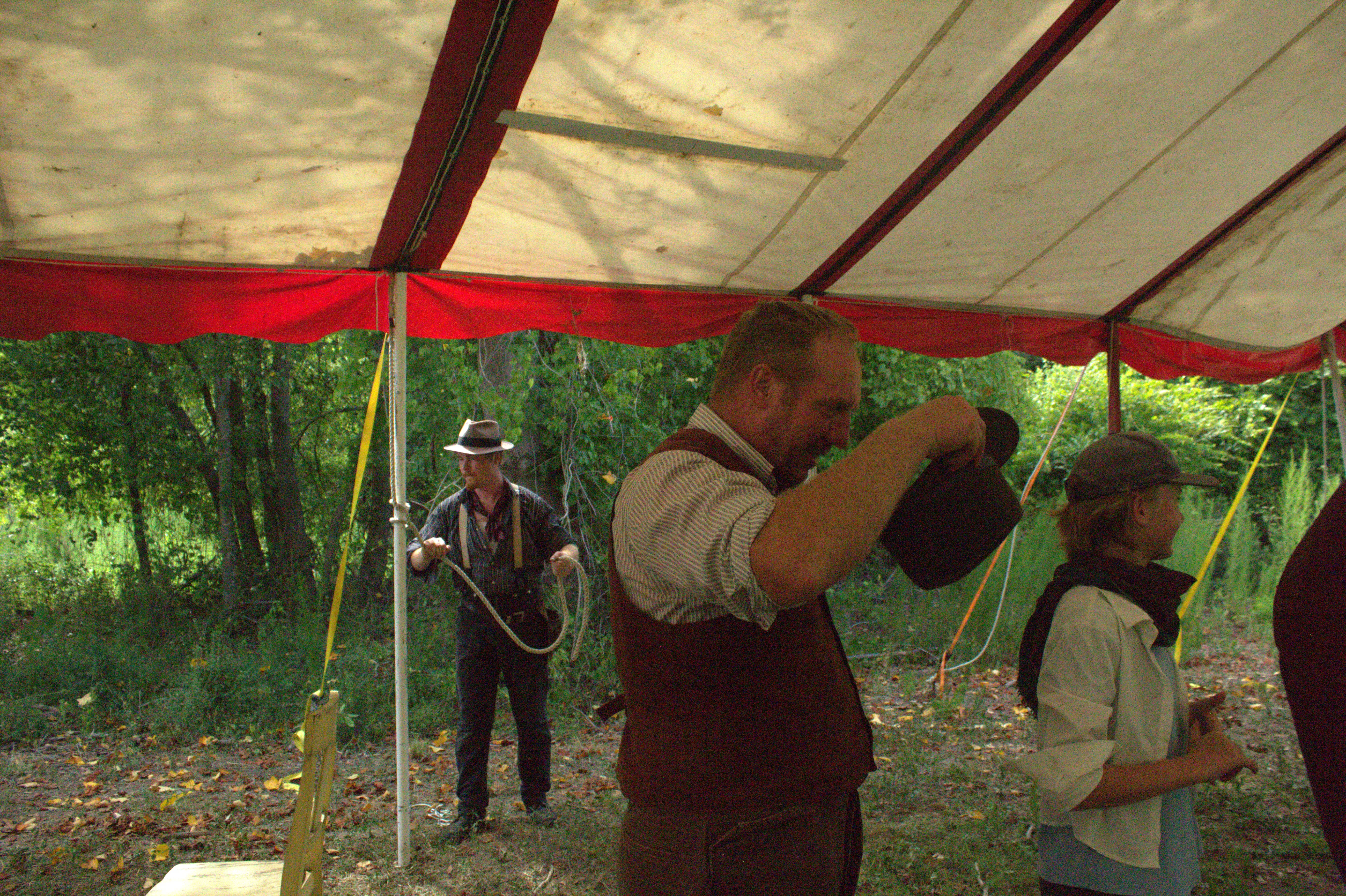 Kuroneko Circus crew raising the big top and coiling rope before a show in North Carolina