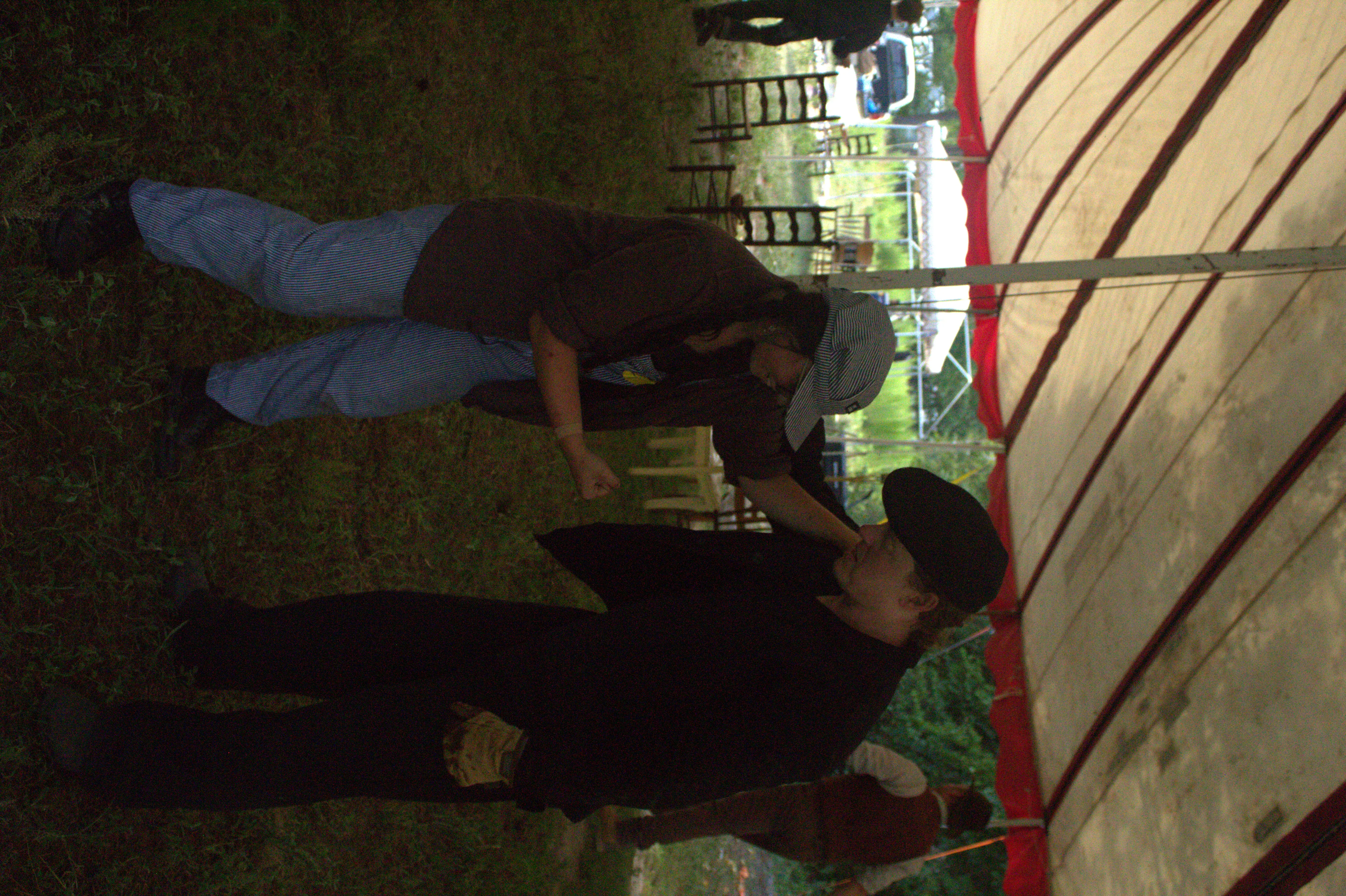 Two performers mid-routine under the tent